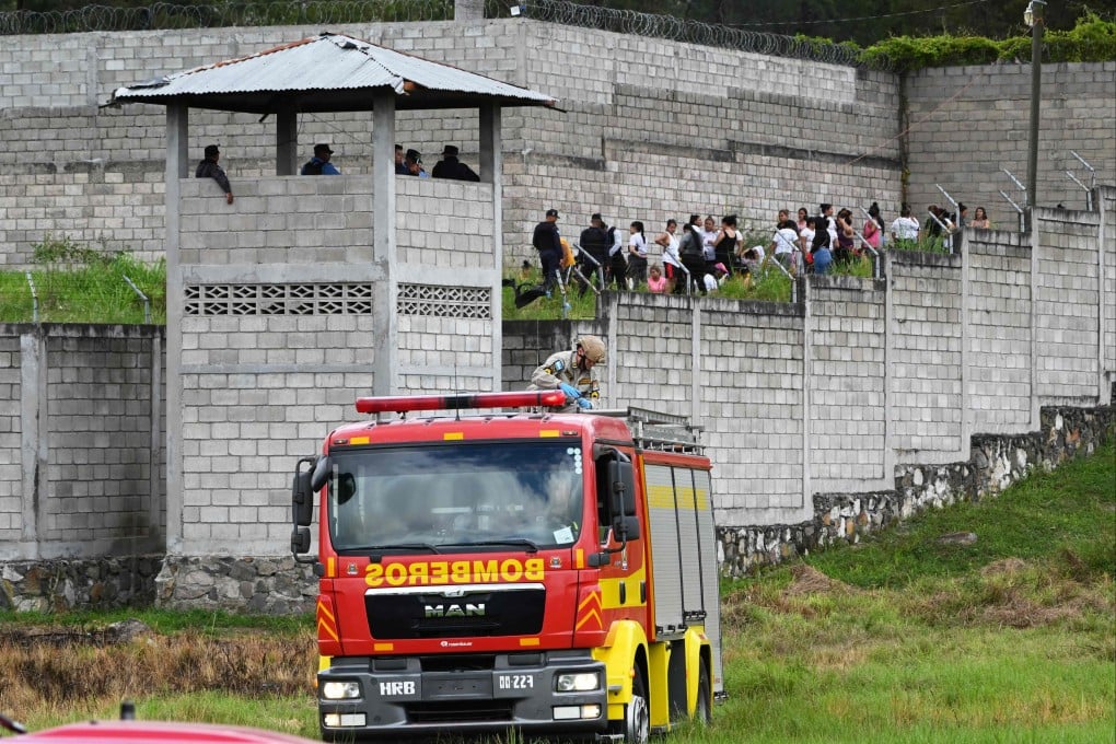 Prison guards watch inmates at the Women’s Centre for Social Adaptation prison in Honduras on Tuesday following a brawl between rival gangs. Photo: AFP