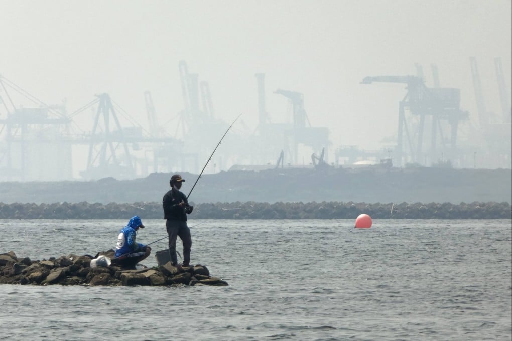 Anglers fish amid thick haze at a coastal area in Jakarta in 2020. Photo: AFP