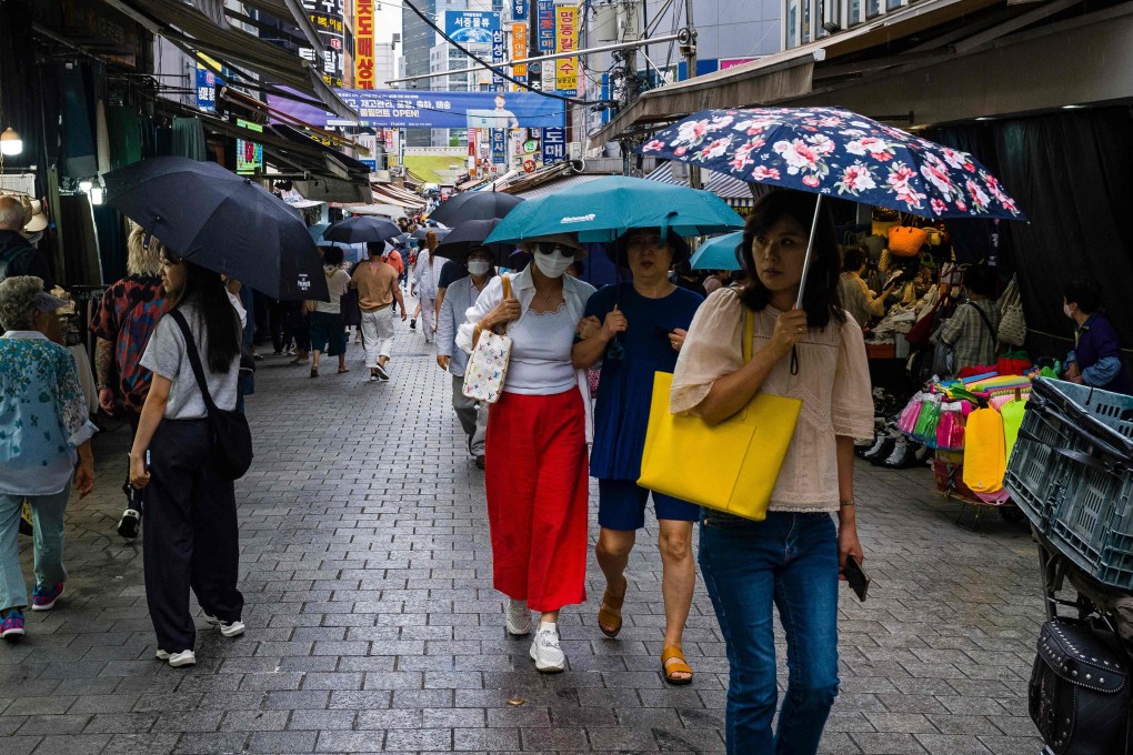 Visitors walk past street stalls at Namdaemun Market in Seoul. Photo: AFP