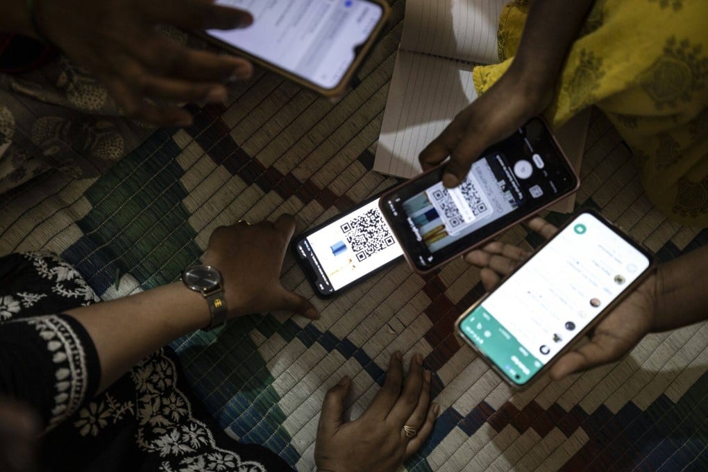 Participants scan a QR code at an AI trial in Bengaluru, India, in April, aimed at helping some of the nation’s poorest more easily access money from anti-poverty programmes. How much will AI be a positive gamechanger in the region? Photo: Bloomberg