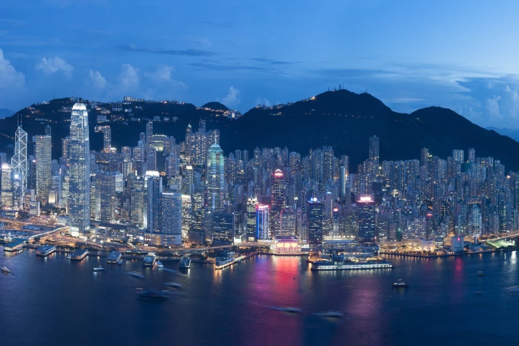 Hong Kong’s iconic skyline as seen at dusk, with skyscrapers lit up against a mountainous backdrop. Photo: Shutterstock