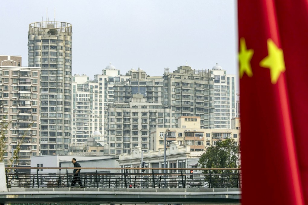 A man walks in front of residential buildings in Shanghai on October 17, 2022. Photo: Bloomberg