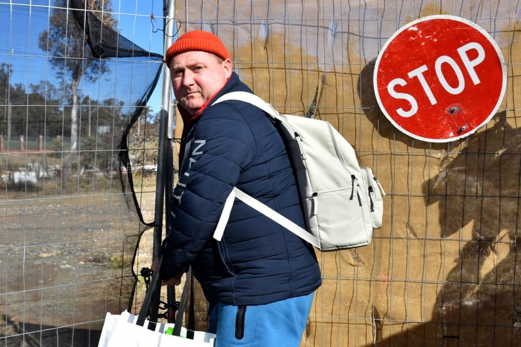 A Russian diplomat leaves a plot of land in Canberra on Monday after Moscow’s attempts to build a new embassy in the Australian capital suffered a legal blow. Photo: AFP