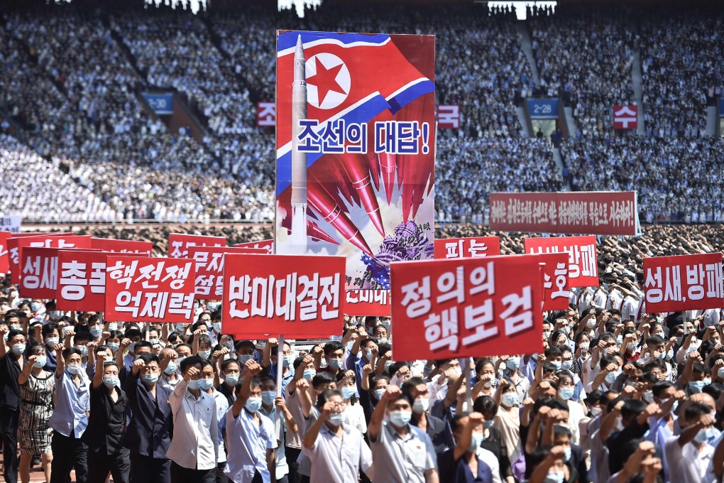 Rally goers in Pyongyang hold banners that read “answer of DPRK”, “nuclear war deterrent”, “anti-US confrontation” and “the nuclear treasured sword of justice” during a mass rally on Sunday to mark the 73rd anniversary of the Korean war. Photo: AFP