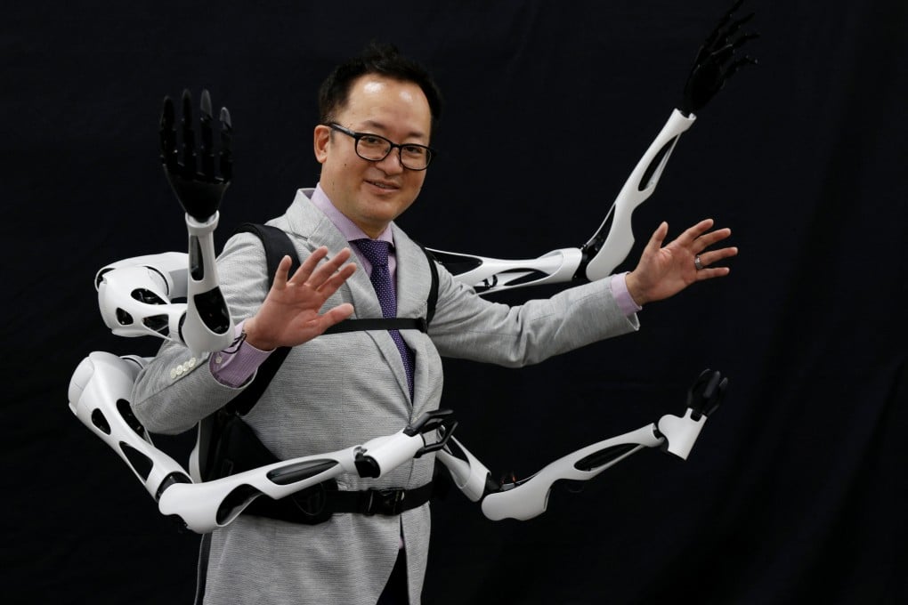 Masahiko Inami of the University of Tokyo poses with the wearable “Jizai Arms” his team developed during a demonstration at his laboratory this month. Photo: Reuters