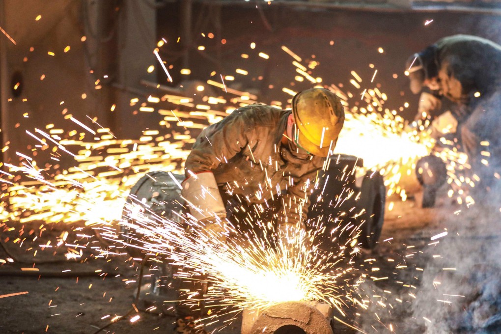 An employee works on steel casting at a foundry in Hangzhou in China’s eastern Zhejiang province on February 23, 2022. Photo: AFP