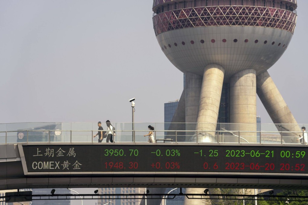 An electronic ticker displays stock figures in in Shanghai. Chinese companies are set to release their second-quarter results in July and August. Photo: Bloomberg