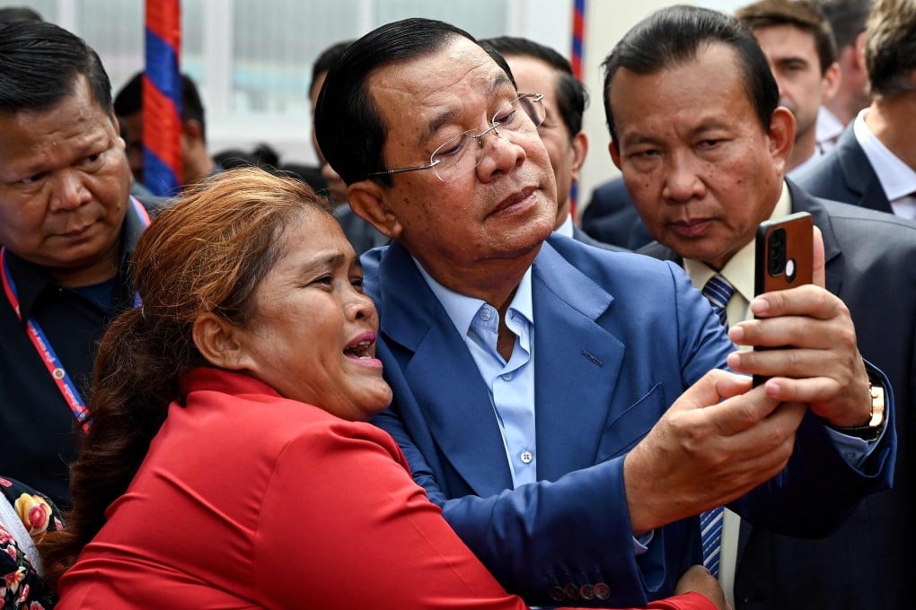 Cambodia’s Prime Minister Hun Sen takes a selfie with a supporter in Phnom Penh on June 19. Photo: AFP