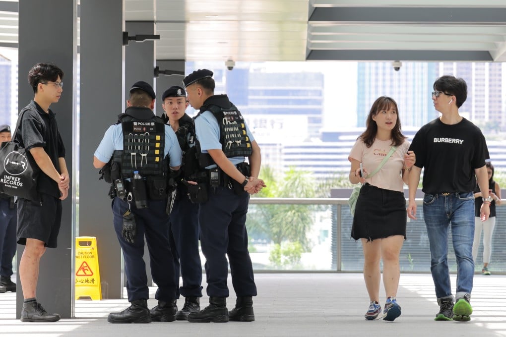Police officers outside the Hong Kong Convention and Exhibition Centre on Friday, where a flag raising ceremony and cocktail reception will be held as part of the commemoration. Photo: Jelly Tse