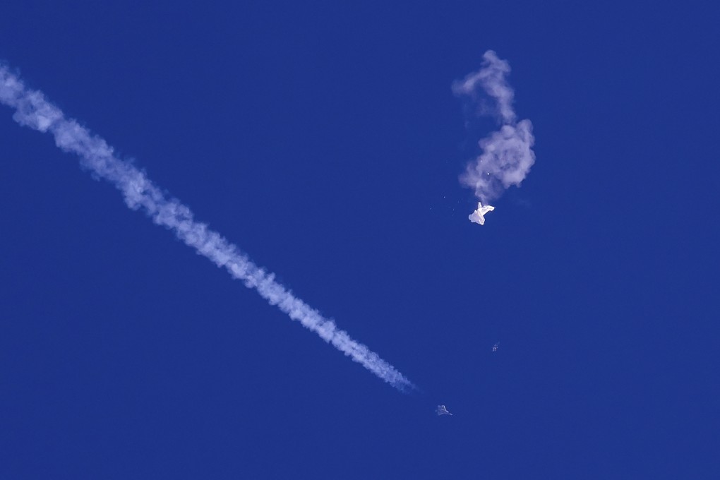 A fighter jet flies past the remnants of a large balloon after it was shot down over the Atlantic Ocean, off the coast of South Carolina, on February 4. Photo: AP