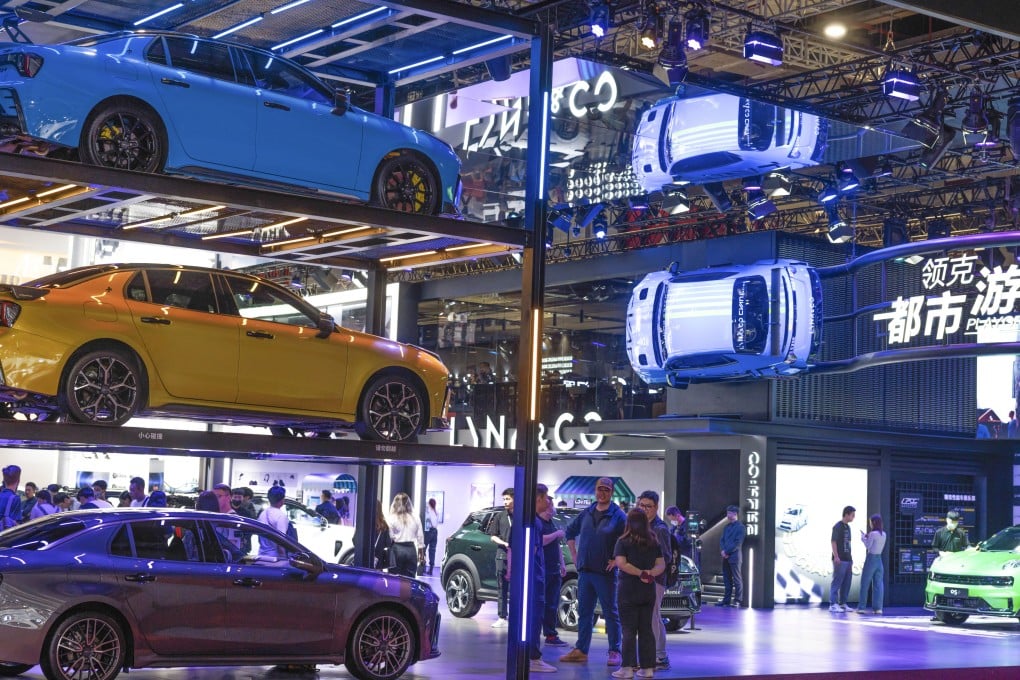 People walk at the Link & Co company booth during the second press day of the 20th Shanghai International Automobile Industry Exhibition in Shanghai on April 19, 2023. China’s auto industry, an electric vehicles in particular, are seen as a bright spot in global semiconductor demand. Photos: EPA-EFE