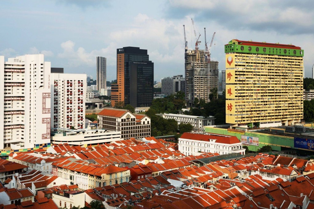 A high-rise residential project is seen under construction near private homes in the Outram area of Singapore last month. The city state’s government expects 40,000 home completions this year – the highest in the last five years – and about 100,000 by 2025. Photo: Bloomberg