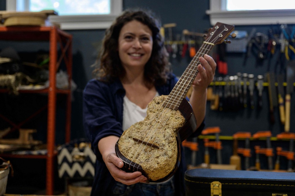French musical instrument maker Rachel Rosenkrantz with a ukulele made using mycelium in her studio on June 21, 2023, in Providence, Rhode Island, US. Her sustainable designs, which include guitars made from mushrooms and honeycomb, are attempts to “help the cause in some way”. Photo: AFP