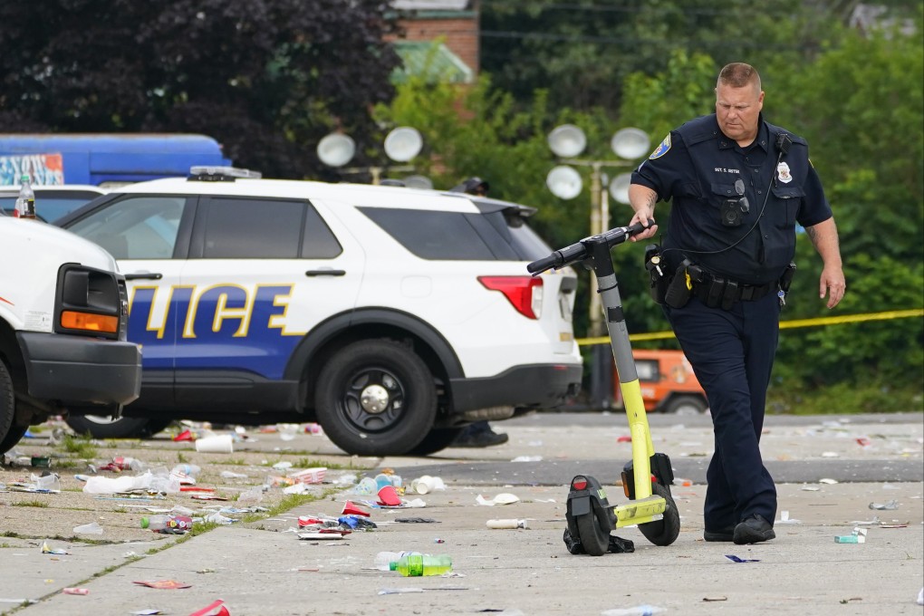 A police officer moves a scooter in the area of a mass shooting incident in Baltimore, Maryland, US on Sunday. Photo: AP