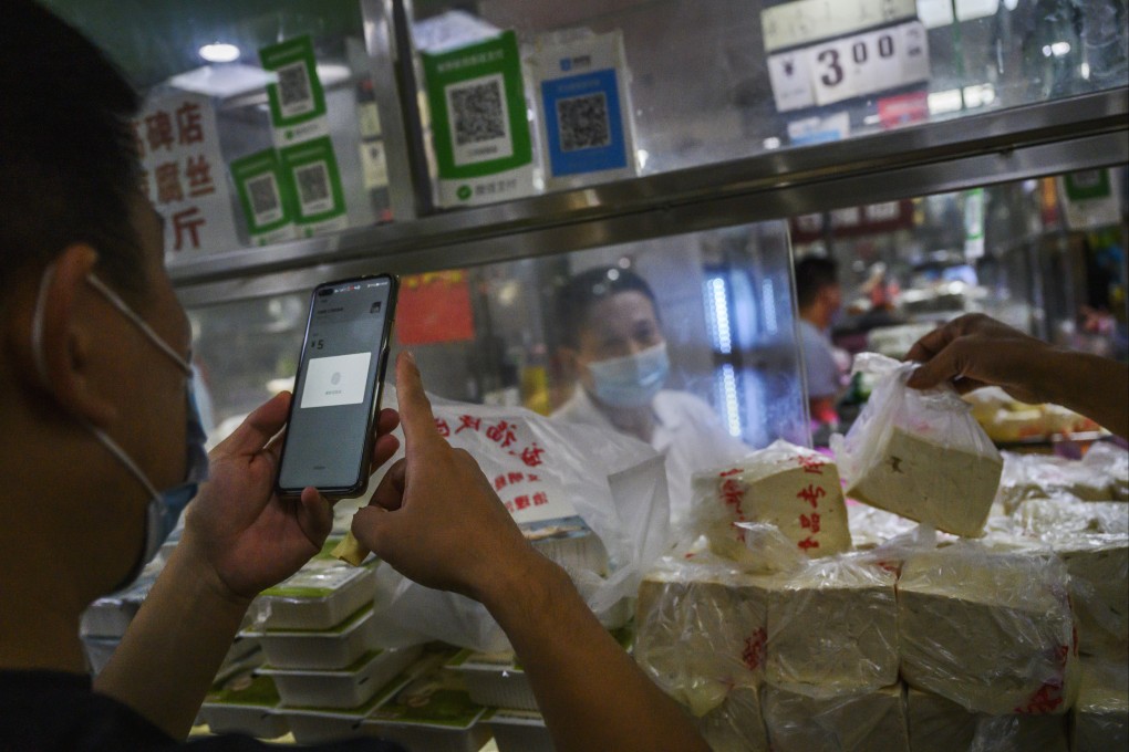 A customer uses his mobile phone to pay via a QR code with the WeChat app in Beijing, September 19, 2020. Photo: Getty Images