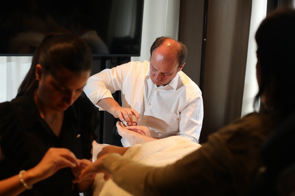 Bastien Gonzalez (centre) and his studio manager, Safa Zidani, give a pedicure and manicure at the Landmark Oriental Spa in Central, Hong Kong. Photo: Xiaomei Chen