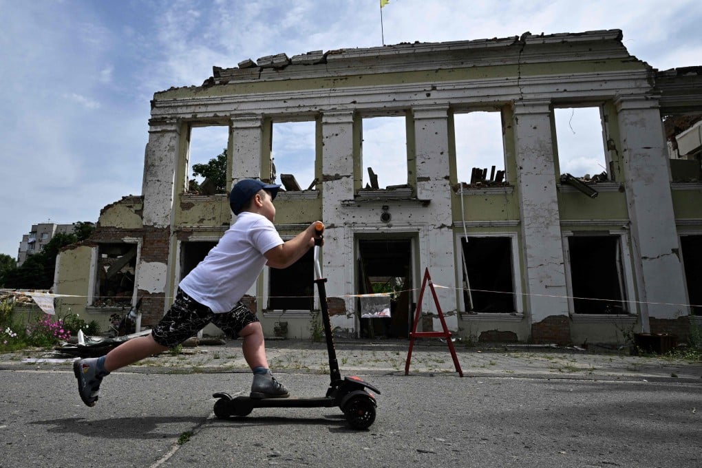 A boy riding his scooter in the Ukrainian city of Okhtyrka. File photo: AFP