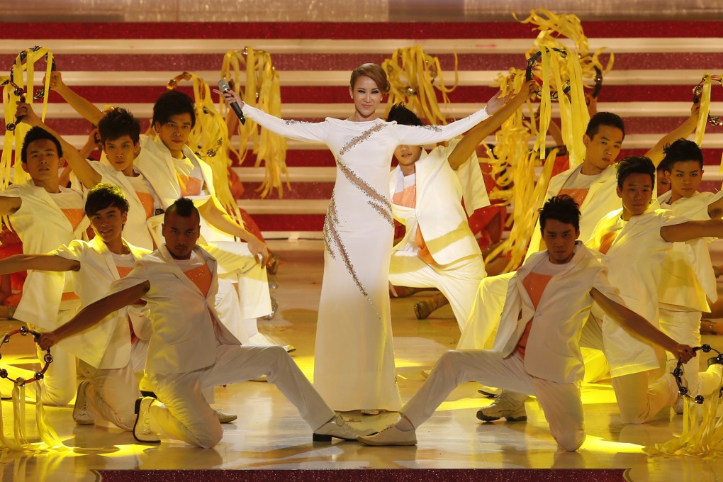Singer Coco Lee, center, is seen perfoming in Hong Kong on the 15th anniversary of the handover of the city on June 30, 2012. She died on Wednesday, aged 48. Photo: AP