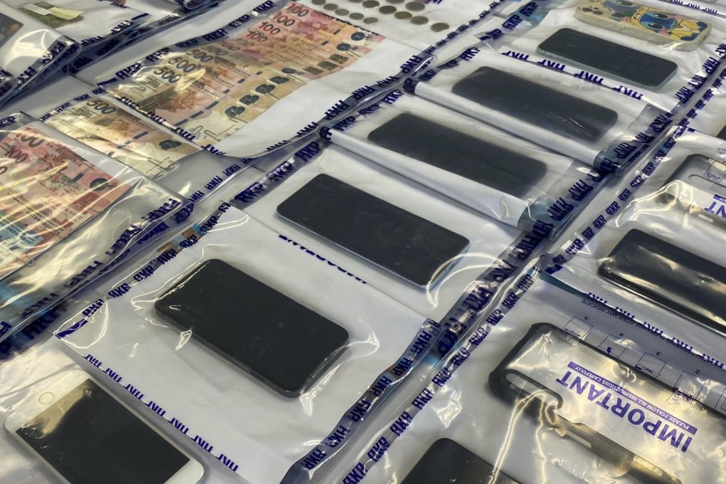 A police display of smartphones and other evidence gathered as part of an anti-deception operation. Photo: Handout