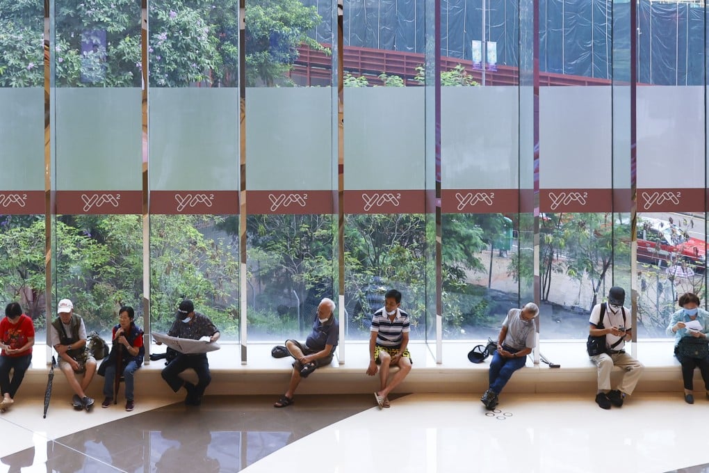 Elderly Hongkongers relax under the large windows of Yue Man Square shopping mall in Kwun Tong on June 16. Photo: Dickson Lee
