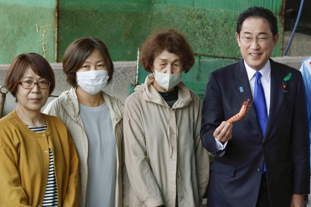 Japanese Prime Minister Fumio Kishida tastes seafood during an election campaign event in Wakayama on April 15. Photo: Kyodo via Reuters