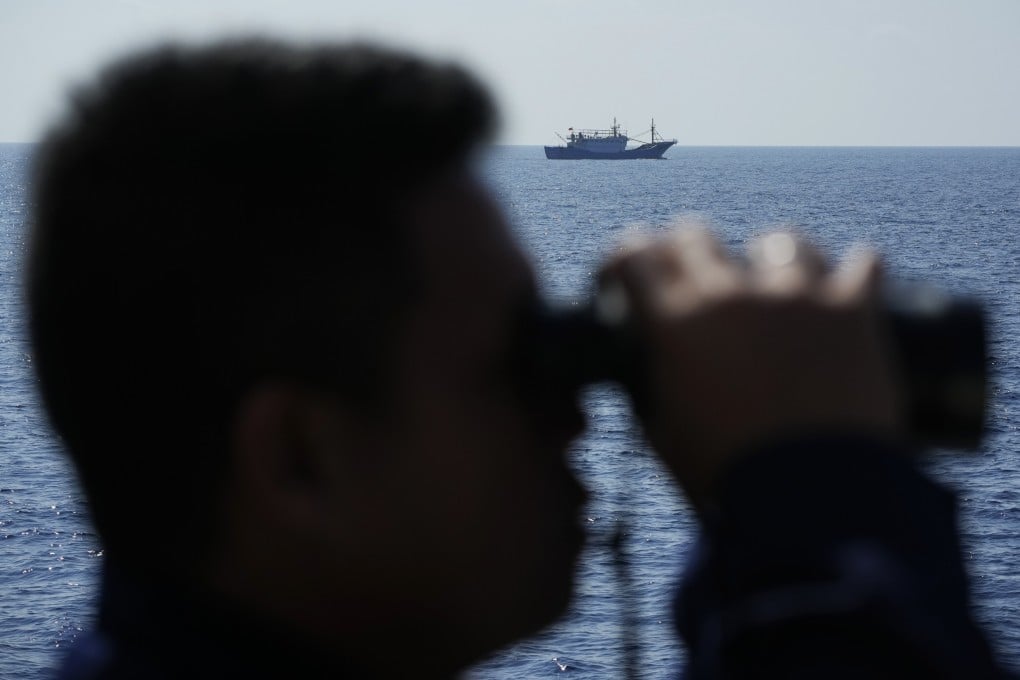 A suspected Chinese militia ship passes a Philippine coastguard vessel in the South China Sea on April 21. Photo: AP