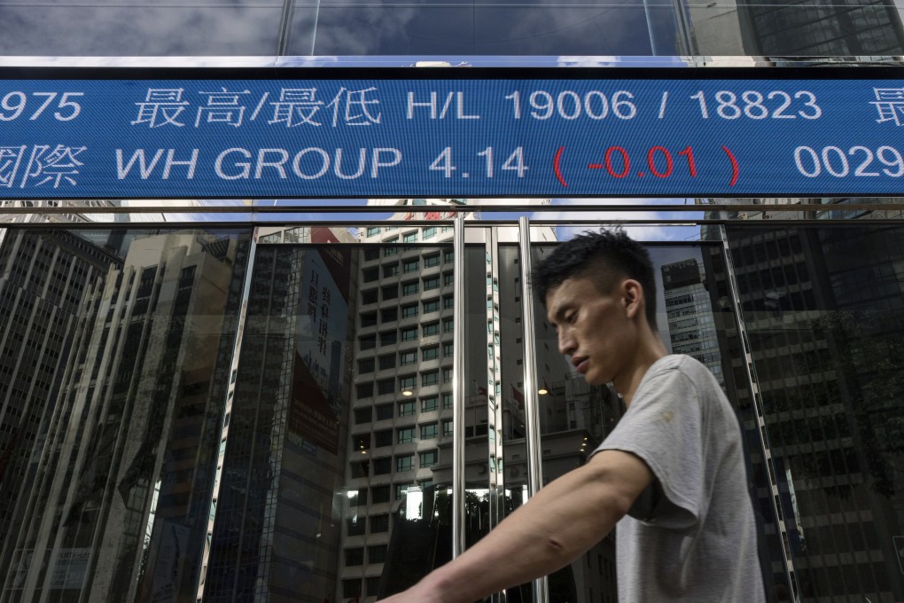 A pedestrian passes by the Hong Kong Stock Exchange in July. Photo: AP