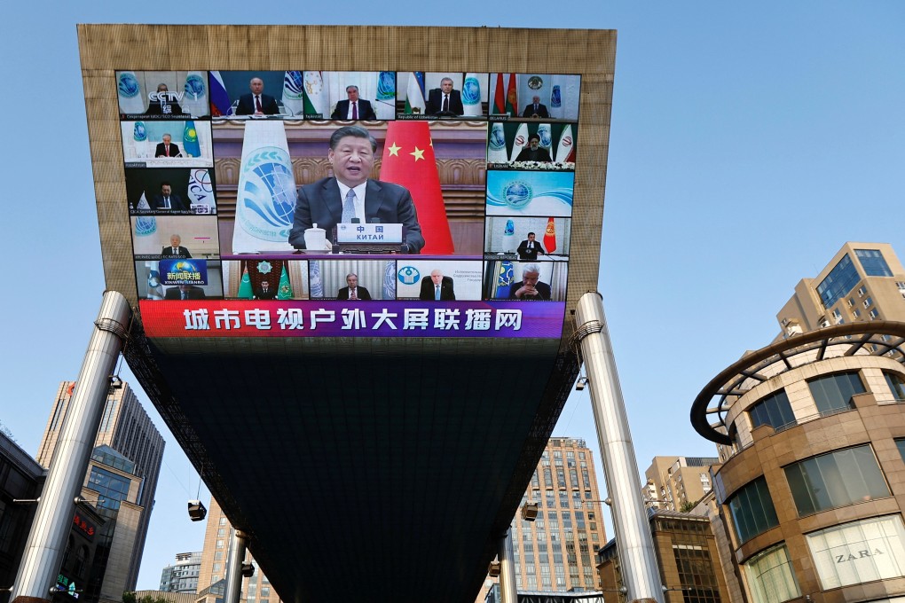 A giant screen broadcasts news footage of Chinese President Xi Jinping’s address to the virtual SCO summit. Photo: Reuters