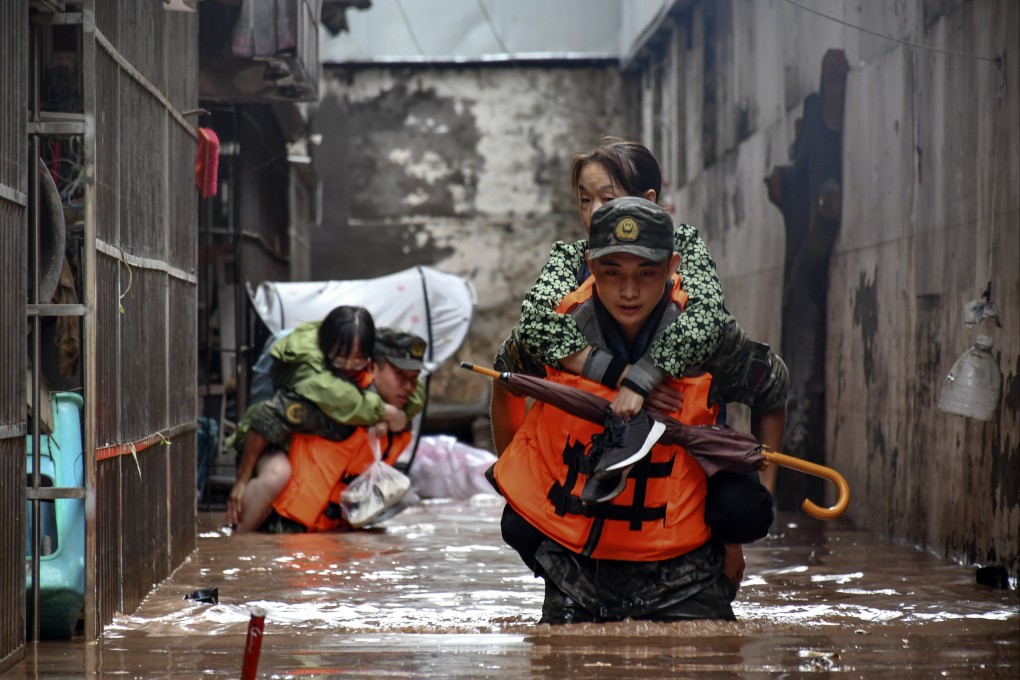 Members of the People’s Armed Police Force evacuate flood trapped residents in Wanzhou district in Chongqing on Tuesday. Photo: Xinhua via AP