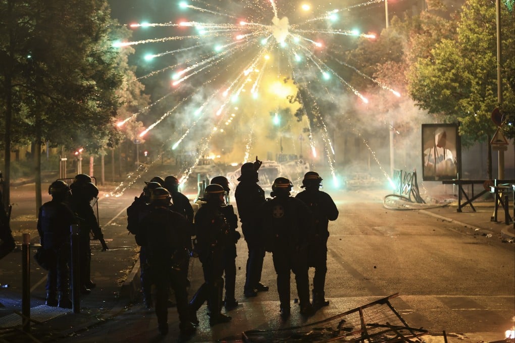 Police stand amid firecrackers on the third night of protests sparked by the fatal police shooting of a 17-year-old in the Paris suburb of Nanterre on June 30. The role of TikTok and other social media platforms in protests across France has come under scrutiny from President Emmanuel Macron and other politicians. Photo: AP