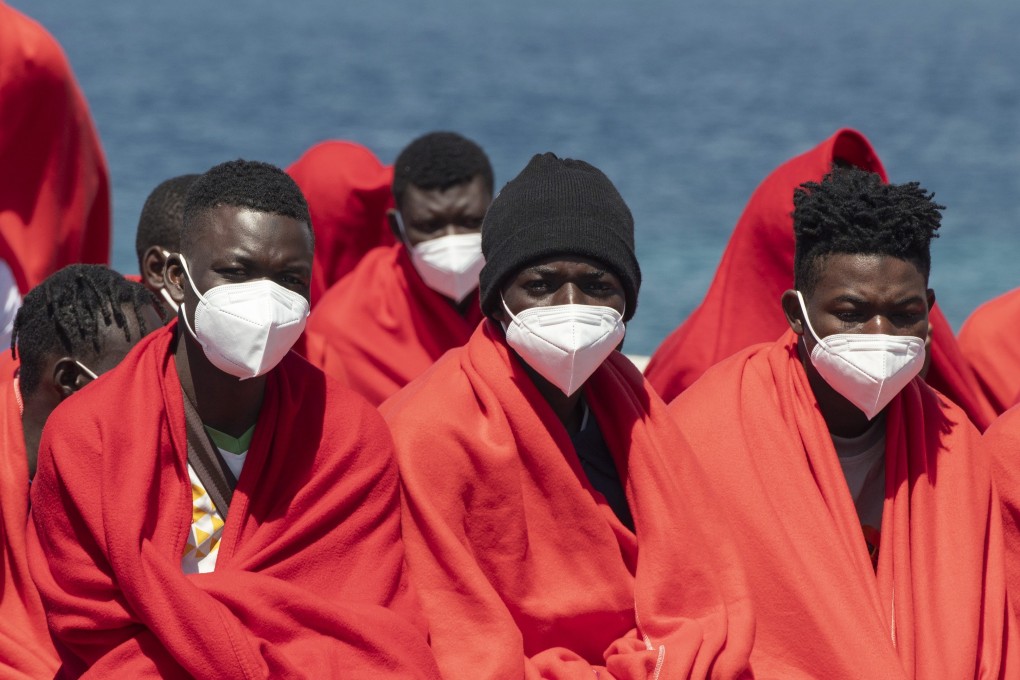 Migrants wait for assistance after disembarking from a rubber boat on Lanzarote island, the Canaries, Spain. Photo: EPA-EFE
