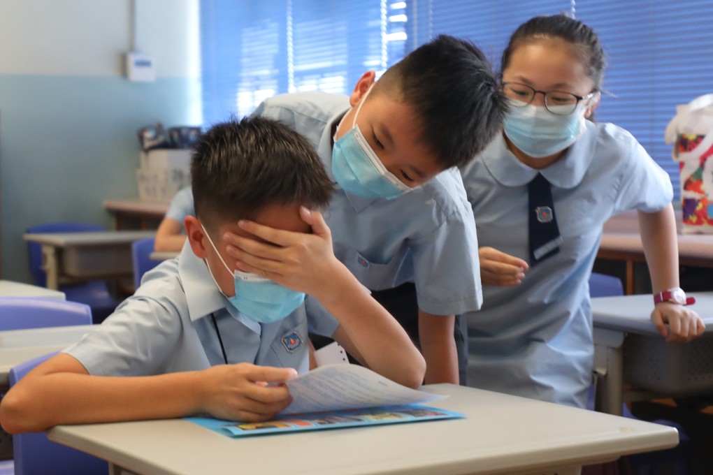 A schoolboy at Yaumati Catholic Primary School is overcome with emotion after he gets a top pick for secondary school in an earlier round. Photo: Xiaomei Chen