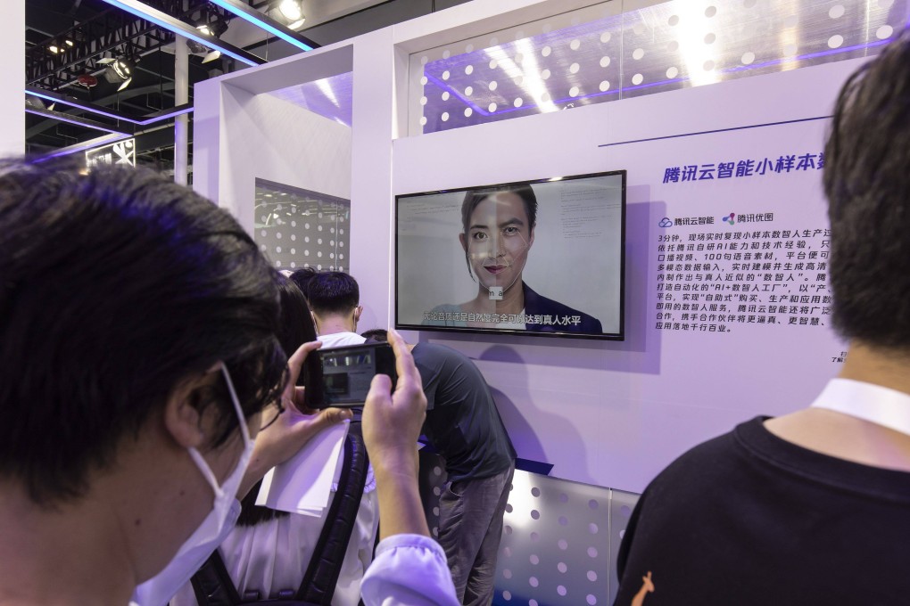 Attendees look at a display on AI generative technology at the Tencent booth at the World Artificial Intelligence Conference (WAIC) in Shanghai, 2023. Photo: Bloomberg