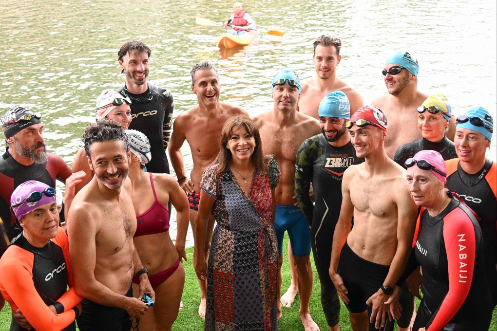 Paris mayor Anne Hidalgo, centre, poses with swimmers during the inauguration of the Bras Marie nautical base in Paris, France on Sunday as she announces the river Seine’s bathing sites planned for Parisians in 2025. Photo: AFP