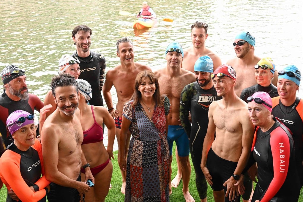 Paris mayor Anne Hidalgo, centre, poses with swimmers during the inauguration of the Bras Marie nautical base in Paris, France on Sunday as she announces the river Seine’s bathing sites planned for Parisians in 2025. Photo: AFP