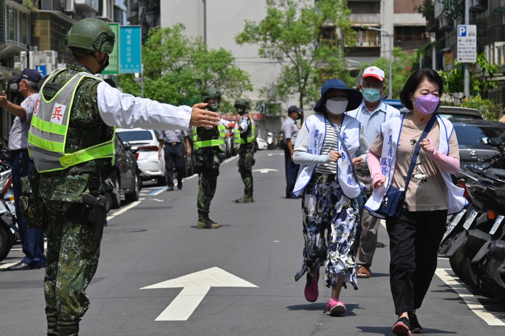 Military personnel guide residents to take shelter during last year’s air-raid drills in Taipei. This year’s exercise starts on July 24. Photo: AFP