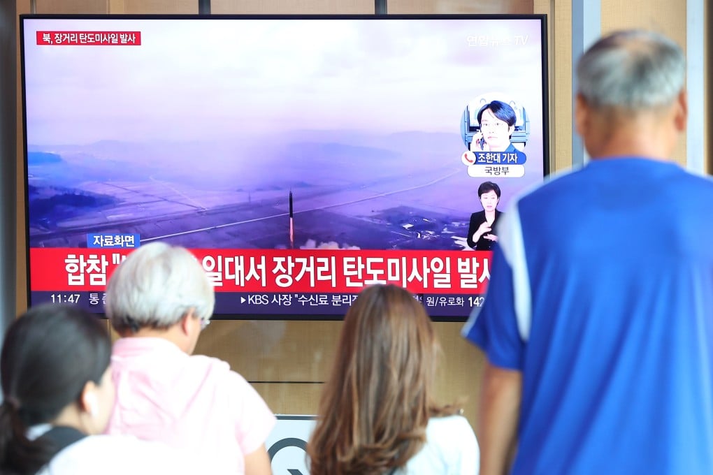 People watch a TV report on North Korea’s launch of an intercontinental ballistic missile. Photo: dpa