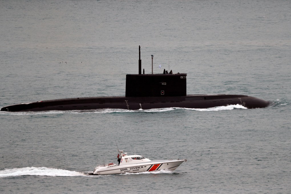 A Turkish coastguard boat escorts Russian submarine Krasnodar in the Bosphorus. On Monday, Russian submarine commander Stanislav Rzhitsky, was gunned down in the Russian city of Krasnodar. Photo: Reuters