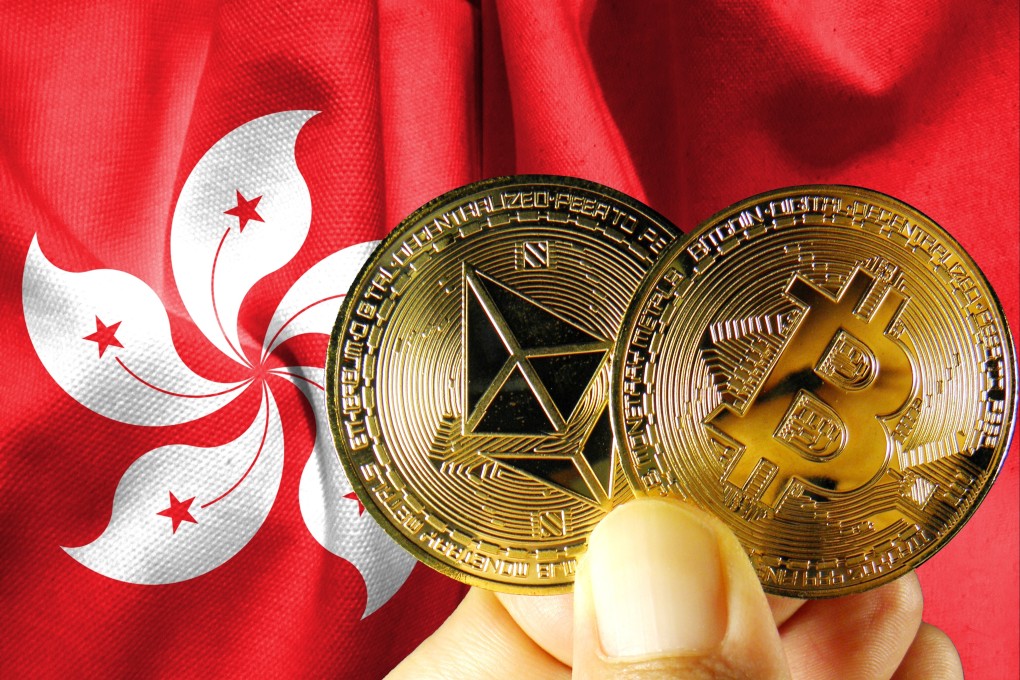 A person holds physical versions of bitcoin against the Hong Kong flag. Photo: Shutterstock Images