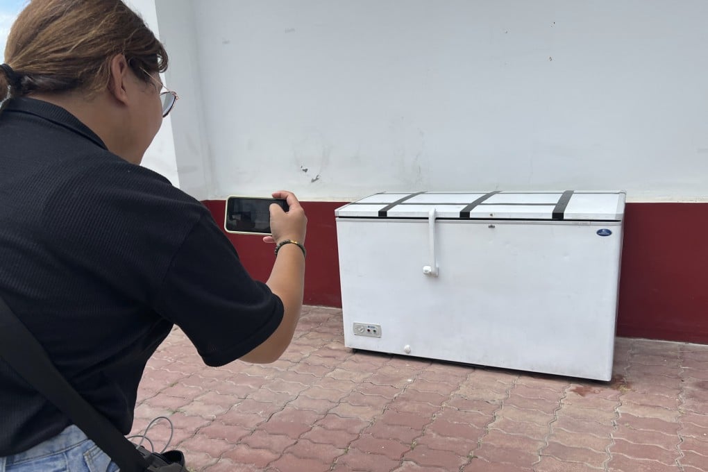 A Thai reporter takes a photo of an empty freezer at the Nong Prue police station in Pattaya. Photo: AP