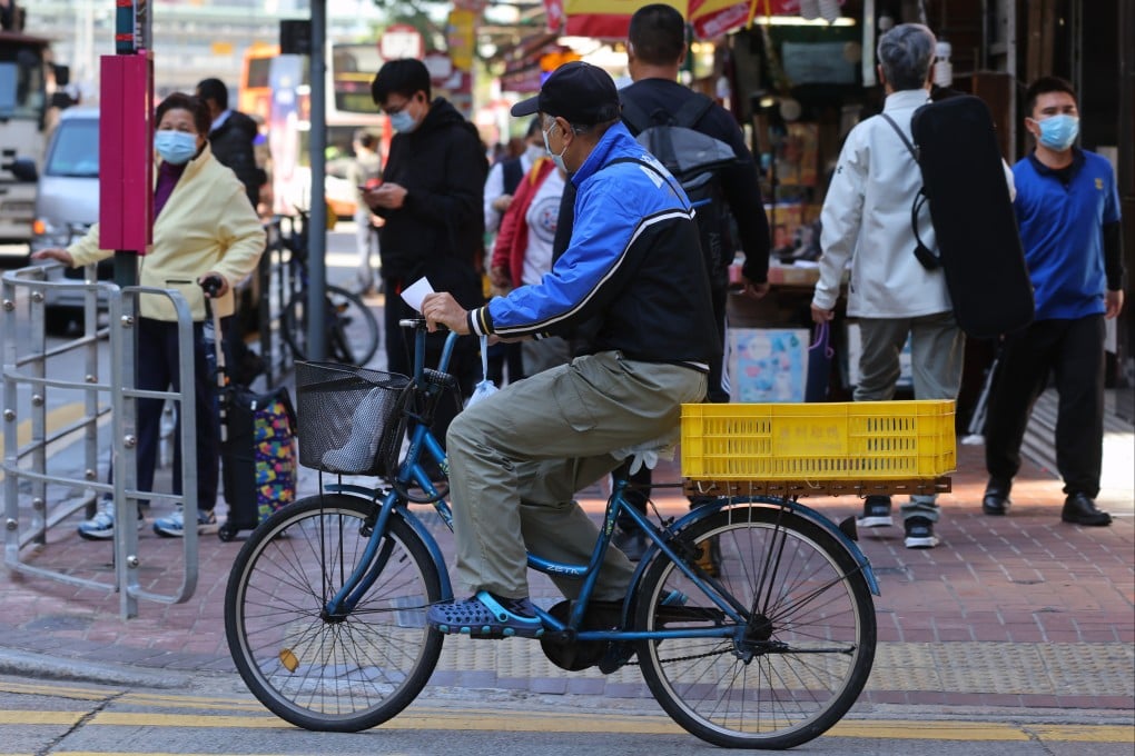 Elderly citizens walking or working near a busy street in Hong Kong in December 2021. Photo: Dickson Lee