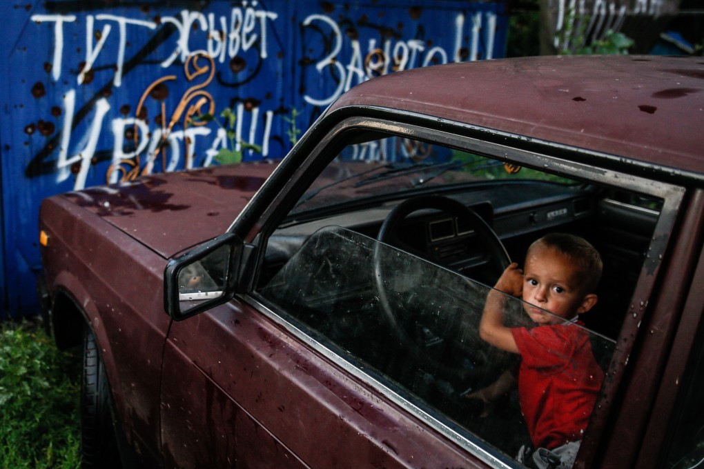 A child looks out of a car window amid Russia’s ongoing invasion of Ukraine, which President Putin said he would use cluster bombs on if necessary. Photo: EPA-EFE