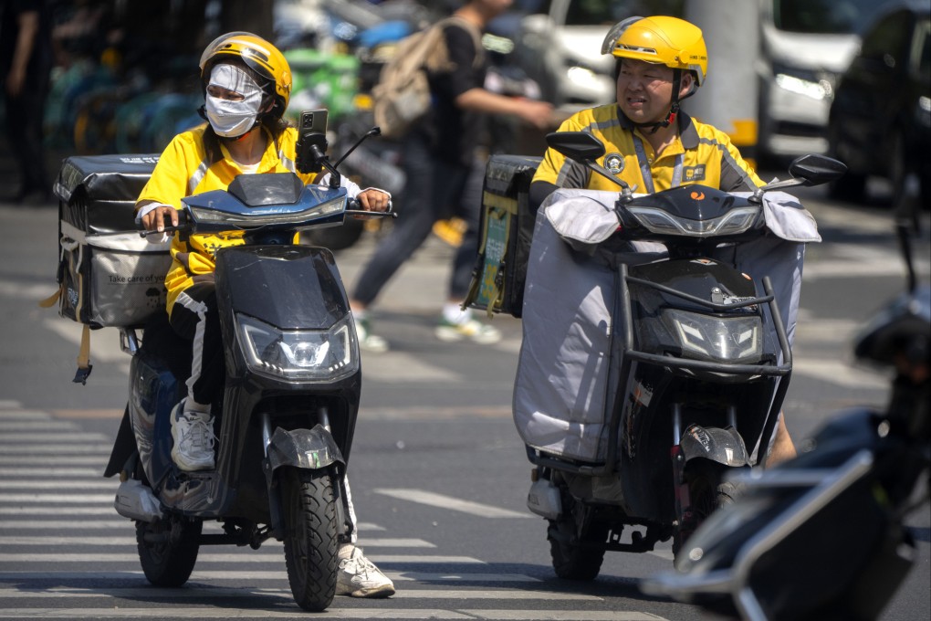 Delivery drivers on an unseasonably hot day in Beijing. Photo: AP Photo