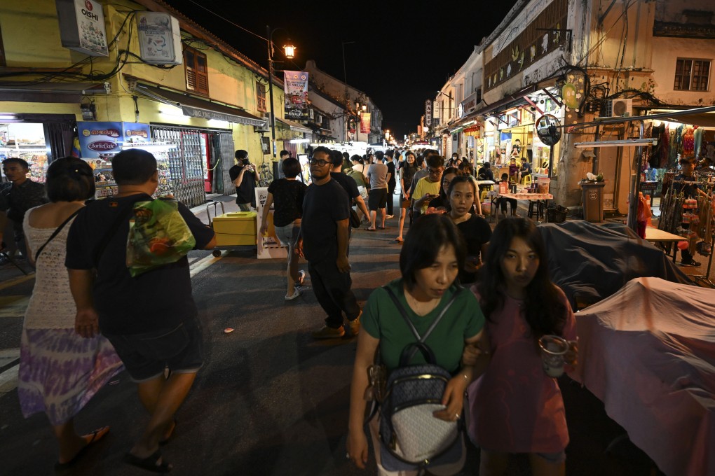 People walk through the Jonker Street Night Market in Melaka city last month. Nine murders were recorded in the state’s Melaka Tengah district, which encompasses Melaka city, in the first six months of this year. Photo: Xinhua