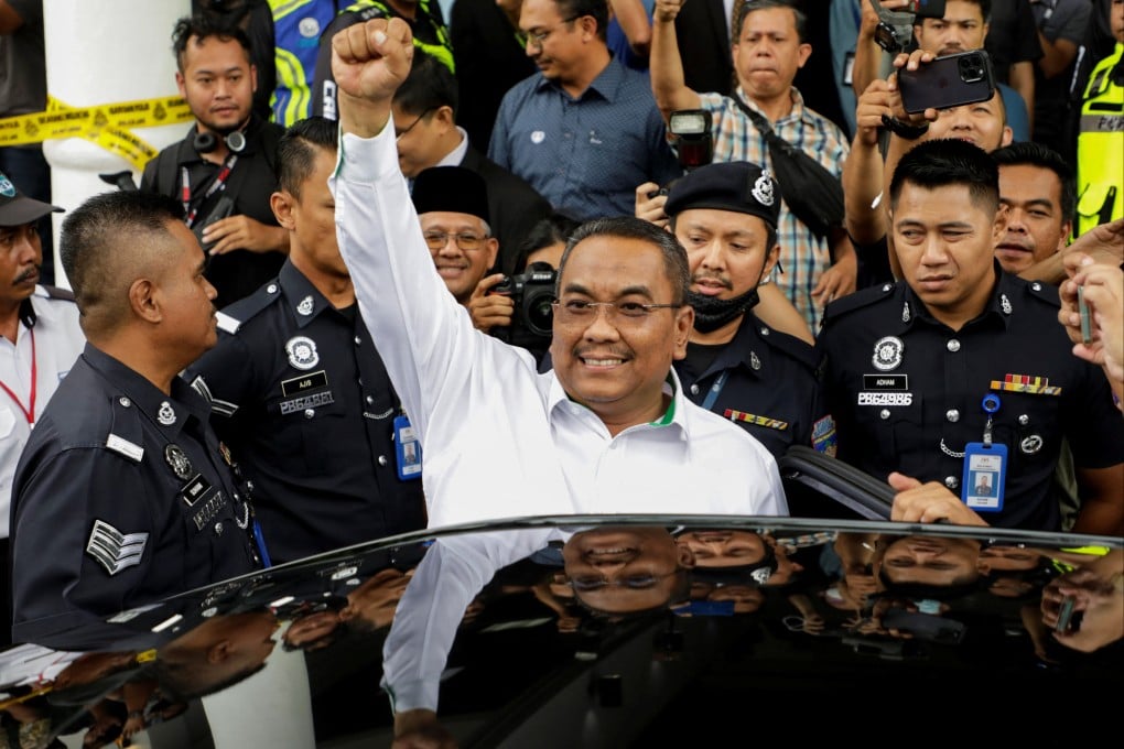 Muhammad Sanusi Md Nor raises his fist as he leaves a court in Gombak on Tuesday after being charged with sedition. Photo: Reuters