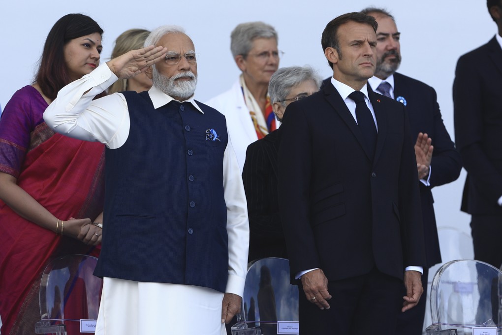 Indian Prime Minister Narendra Modi salutes Indian troops as French President Emmanuel Macron looks on during the Bastille Day military parade Friday, July 14, 2023 in Paris. India is the guest of honor at this year’s Bastille Day parade, with Prime Minister Narendra Modi in the presidential tribune alongside French President Emmanuel Macron. (AP Photo/Aurelien Morissard)