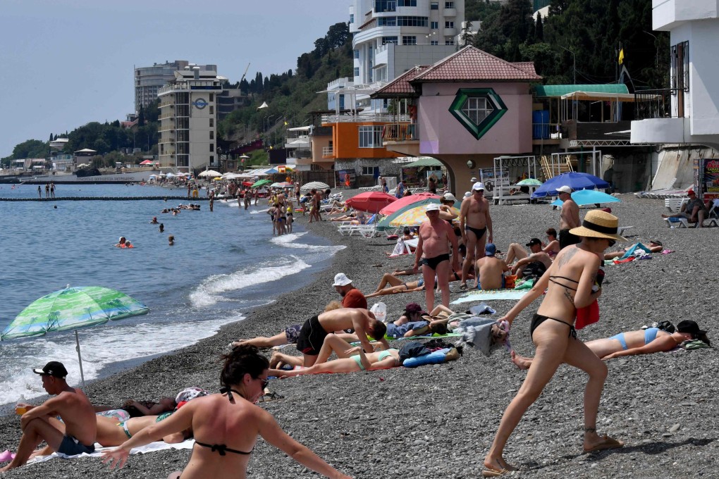 People relax on a beach in the resort town of Alushta on the Crimean peninsula in June. Photo: AFP