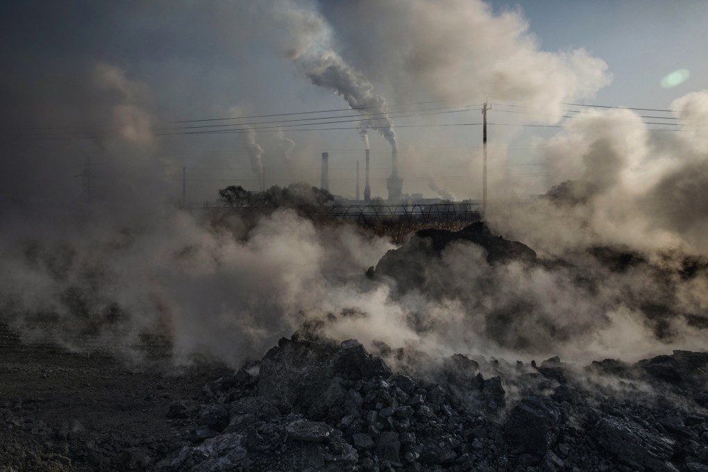 Steam and smoke from waste coal and stone rises after being dumped next to an unauthorized steel factory in Inner Mongolia, China. Photo: Getty Images