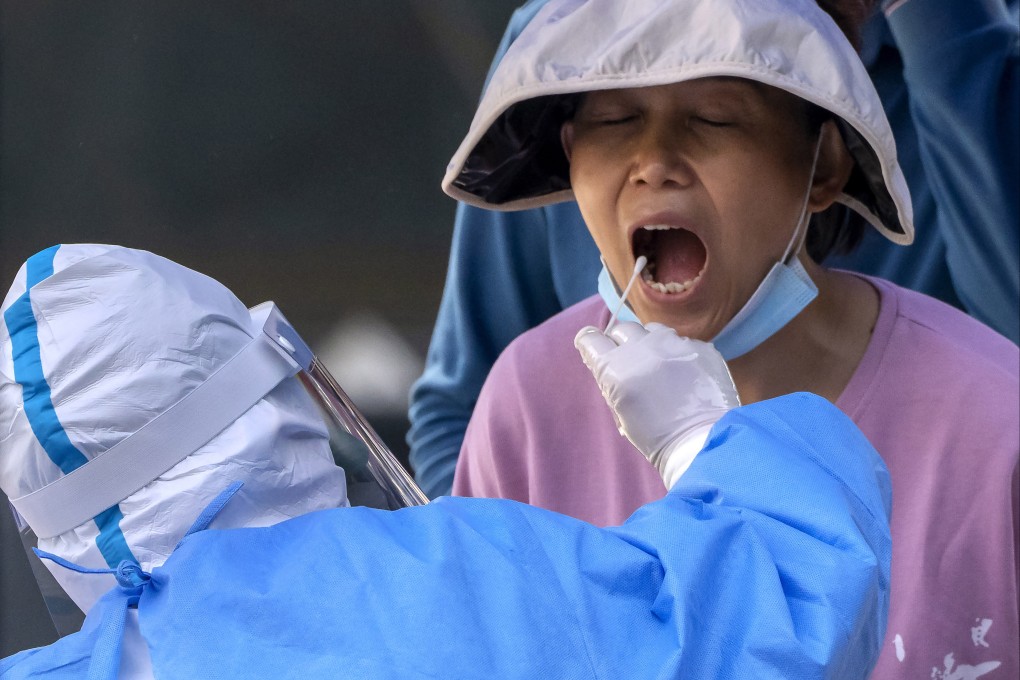 A worker wearing a protective suit swabs a woman’s throat in a Covid-19 test in May 2022. In the pandemic’s wake, the formation of a global partnership to study emerging infectious diseases is a positive step. Photo: AP
