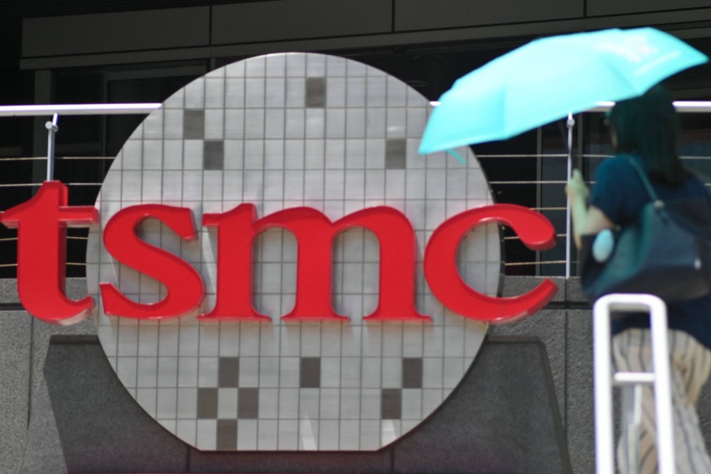 A woman walks past a TSMC logo at the Hsinchu Science Park in Hsinchu, Taiwan, on July 5, 2023. Photo: AFP
